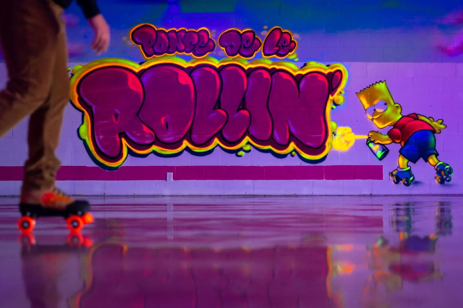 Ponce De Le Rollin' skating rink — skater on the rink with Bart Simpson mural